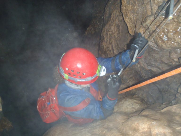 Carol descending the 20ft ladder, Swildon’s Hole Wet adventure caving - ladder descent!
